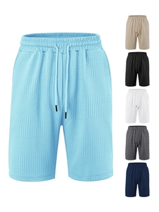 Detailed close-up of waffle textured fabric colors and drawstring elastic waistband on shorts