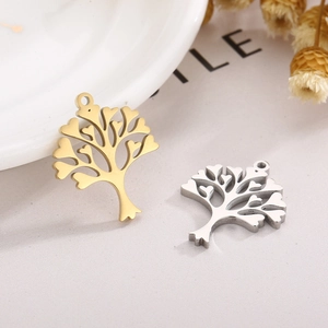 Macro shot of tree of life pendants with heart leaves in gold and silver finishes
