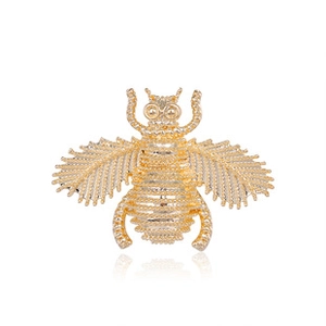 Detailed view of a gold-plated bee brooch with intricate hollowed texture and glossy finish