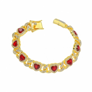 Gold hip hop bracelet featuring red heart gems and sparkling rhinestones on white background