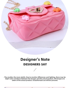 Detail of pink jelly mini bag with 3D cartoon charms and gold heart twist lock clasp