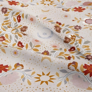 Close-up of bohemian tapestry fabric with sun and moon celestial floral patterns