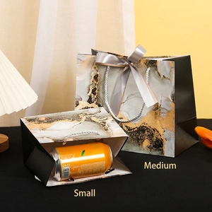 Ink marble gift bags with gold foil accents and silk ribbons in small and medium sizes