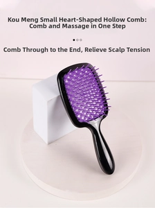 Detail of purple heart-shaped hollow-out vented hairbrush with ergonomic black handle