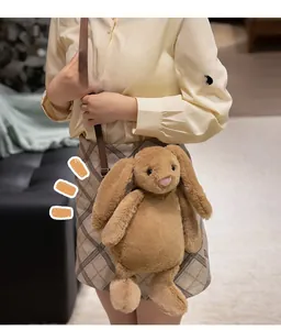 Detailed view of plush brown rabbit crossbody bag with adjustable strap on a model