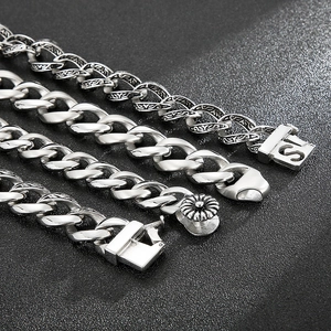 Detailed view of four vintage punk style titanium steel bracelets on black background