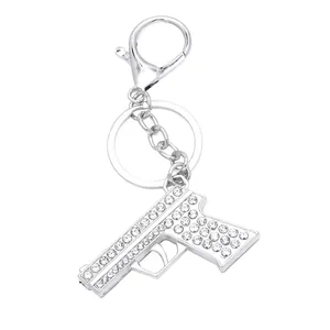Hip hop pistol keychain with sparkling white rhinestones on silver metal finish