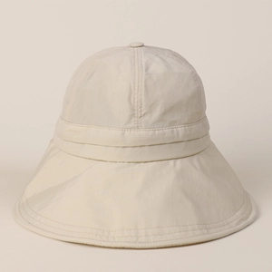 Macro shot of quick-dry nylon fabric texture on beige sun hat with detailed stitching