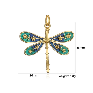 Golden dragonfly pendant with blue green enamel wings and flower detail 26x23mm