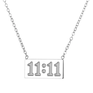 Macro shot of silver rectangle pendant featuring detailed 11:11 engraving on chain