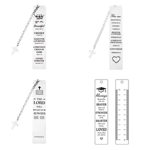 Close-up of silver stainless steel bookmarks with cross charms and engraved bible verses