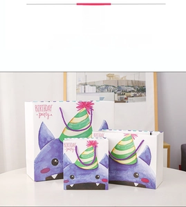 Three sizes of cartoon monster gift bags with purple handles for birthday parties