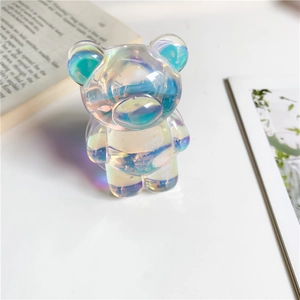 Macro shot of a holographic cartoon bear phone grip showing iridescent light and details