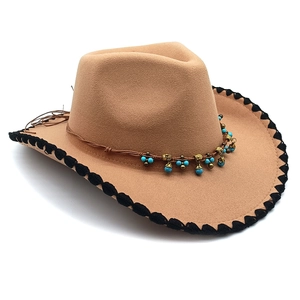 Detailed view of camel felt fedora hat featuring blue turquoise beads and metallic charms