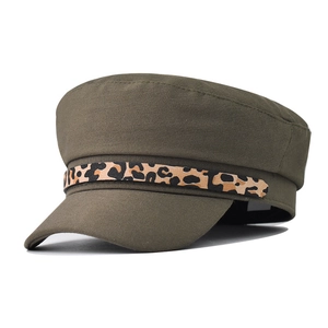 Detail of leopard print band on olive green newsboy cap with cotton twill texture