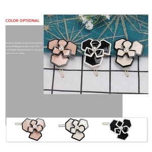 Three acetate hair clips with hexagonal camellia flowers and pearls on a gold-tone base