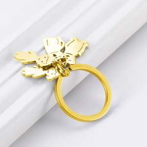 Detailed close-up of golden stainless steel keychains featuring boy and girl pendants