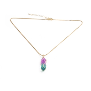 Close-up of gold chain necklace with purple and green crystal pendant wrapped in gold wire