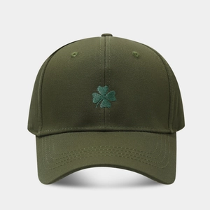 Close-up of green four-leaf clover embroidery on dark army green cotton baseball cap