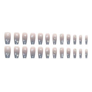 Detail of blue gradient coffin nails with silver glitter and rhinestone star designs