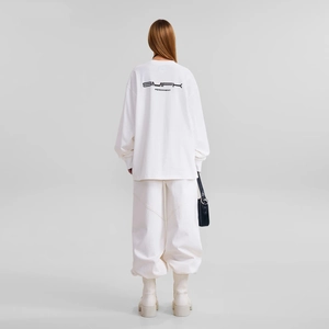 Detail of white oversize long sleeve T-shirt with SMFK PERMANENT back print and gray background