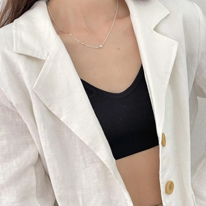 Minimalist silver beaded snake chain necklace worn with a white linen blazer for a chic look
