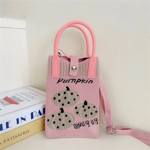 Close-up of pink knitted bag featuring embroidered pumpkin patterns and PUMPKIN 03 text