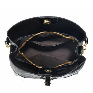 Internal view of black crocodile pattern bag showing double magnetic buckles and compartments