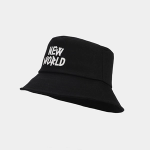 Detail of black cotton bucket hat featuring NEW WORLD white typography and textured fabric