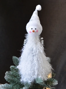 Detail of plush snowman Christmas hat with silver stars and shimmering fringe texture