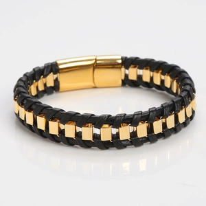 Handmade black woven leather bracelet with gold metal accents and magnetic clasp