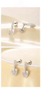 Detailed view of silver shovel stud earrings with cubic zirconia and screw back