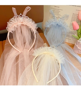 Detailed view of pink, blue, and white princess crown headbands with lace veils