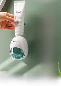 Detail showing wall-mounted automatic toothpaste dispenser mechanism and airtight design