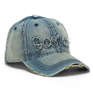 Detail view of the washed denim baseball cap featuring vintage BOSTON embroidery and distressed brim