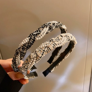 Detail of tweed fabric hairbands with pearl weave and elegant checkerboard pattern