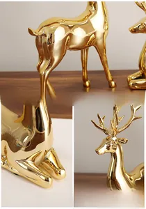 Detail of elegant gold electroplated elk figurines with mirror finish for luxury home decor