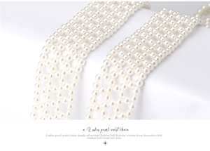 Close-up detail of white pearl woven waist chain belt with intricate mesh structure