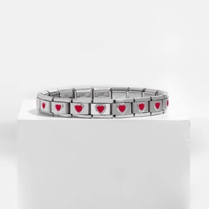 Detailed view of stainless steel modular links featuring red heart charms on a white stand