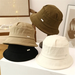 Textured waffle knit bucket hats for women in four autumn colors with metal logo tags