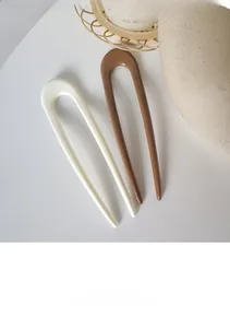 Minimalist U-shaped hair forks in creamy white and coffee brown with glossy finish