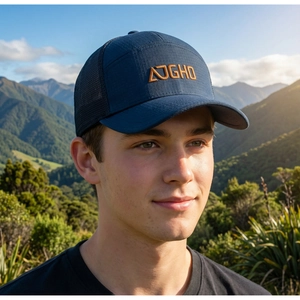 Detail of outdoor trucker hat with orange embroidery logo and breathable mesh back