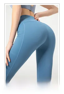 Detail of high-waisted yoga pants with side pockets and peach lift stitching in mist blue