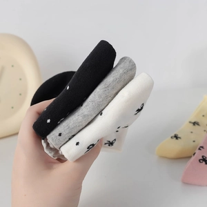Close-up of cotton blend socks with cute bow details and polka dot patterns in multiple colors