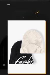 Detail of distressed knit beanies in black and beige showing frayed edge design