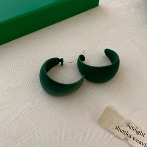 Deep green C-shaped acrylic earrings with a matte flocking finish and silver pins