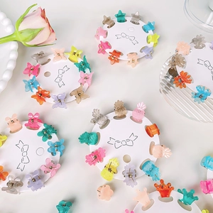 Colorful mini hair claw set with butterfly and star shapes on a round white display card