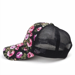 Detail view of the breathable black mesh and floral print fabric on the baseball cap