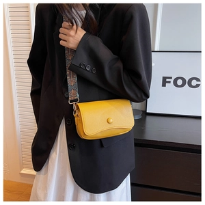Yellow pebbled PU crossbody bag featuring a colorful wide fabric strap and sleek design