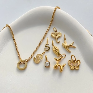 Collection of gold stainless steel DIY charms including butterfly and balloon dog